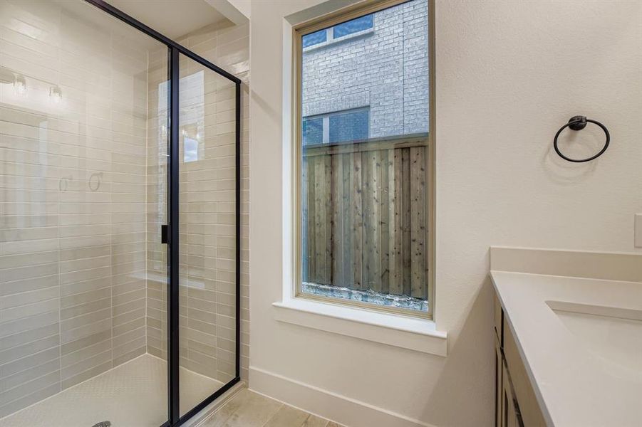 Bathroom featuring vanity and a shower stall Bathroom featuring vanity and a shower stall