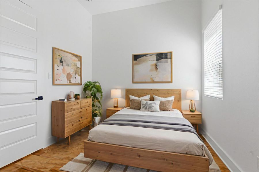 Versatile first-floor bedroom featuring a private en-suite bath—virtually staged to showcase its full potential as a guest suite.
