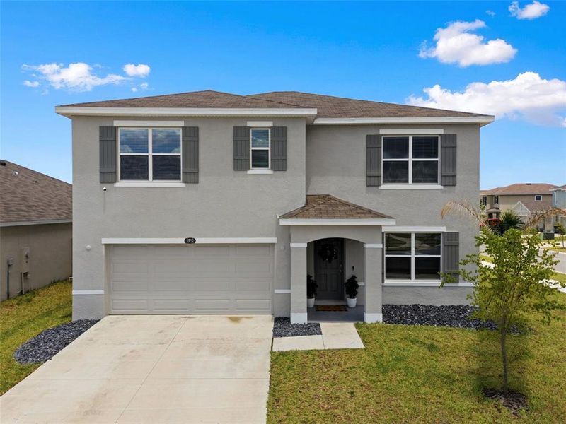 Front exterior of a new home in Epperson, Wesley Chapel, FL, highlighting curb appeal (Image 24). Front exterior of a new home in Epperson, Wesley Chapel, FL, highlighting curb appeal (Image 24).