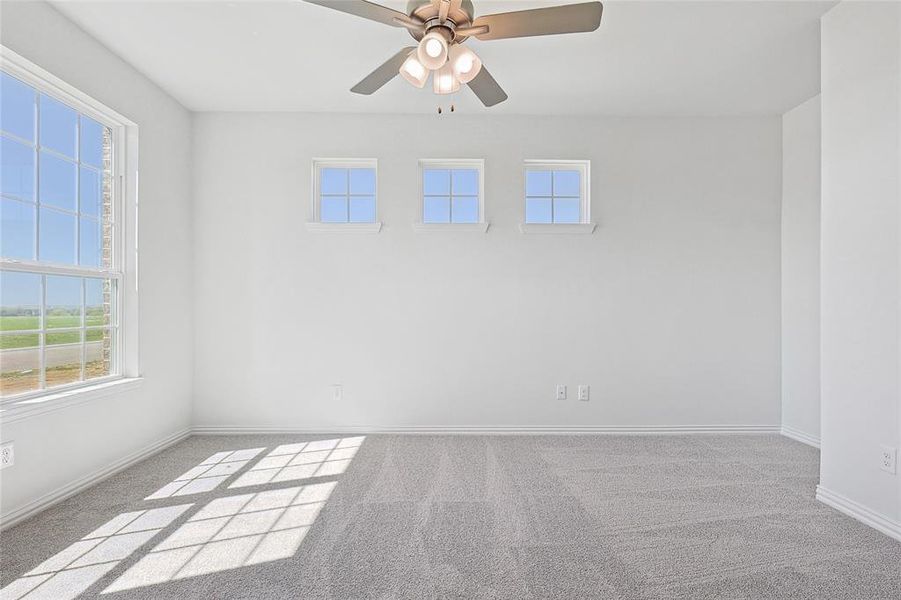 Unfurnished room with light carpet and ceiling fan