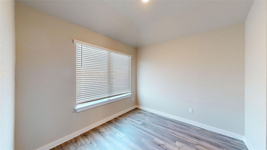 Comfortable room featuring durable vinyl plank flooring and ample natural illumination. Comfortable room featuring durable vinyl plank flooring and ample natural illumination.