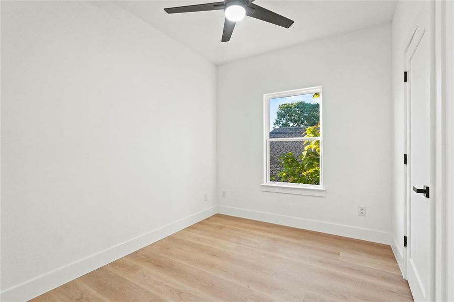 Unfurnished room with light wood-style flooring and a ceiling fan Unfurnished room with light wood-style flooring and a ceiling fan