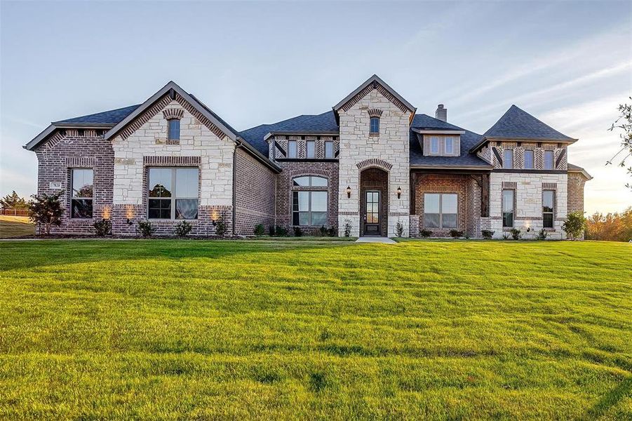 French country style house with a front lawn