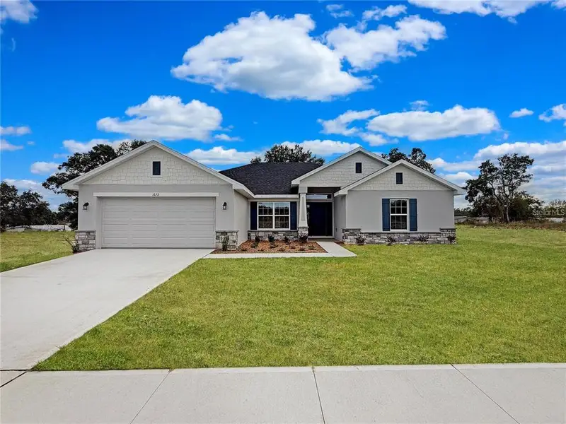 Front exterior of a new home in Arbor Park, Leesburg, FL, highlighting curb appeal (Image 1). Front exterior of a new home in Arbor Park, Leesburg, FL, highlighting curb appeal (Image 1).