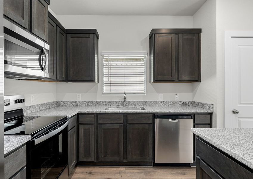 The kitchen has sprawling granite countertops.