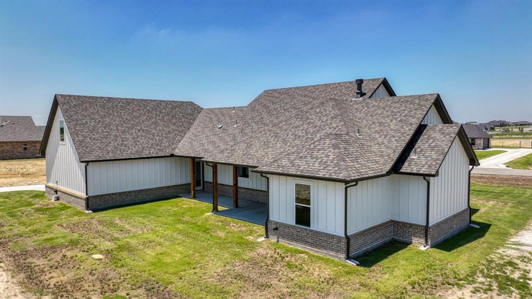 Rear view of property featuring a yard