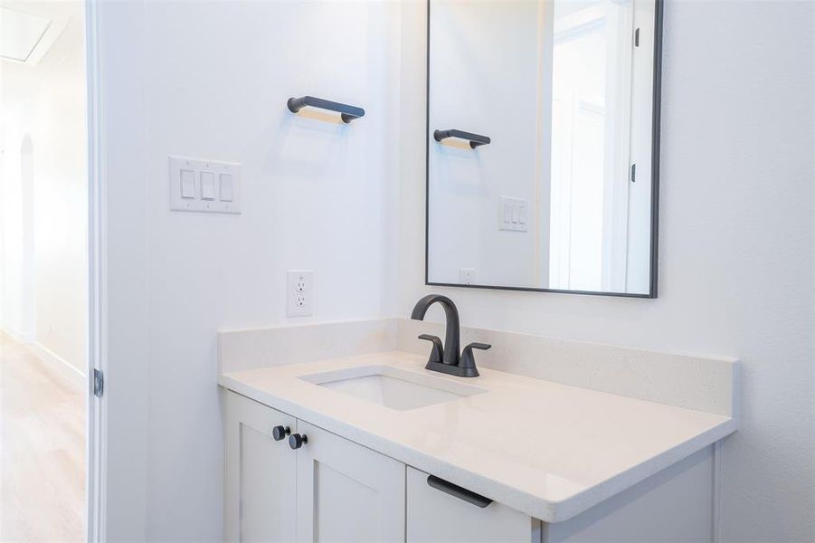 Bathroom with vanity and wood-type flooring