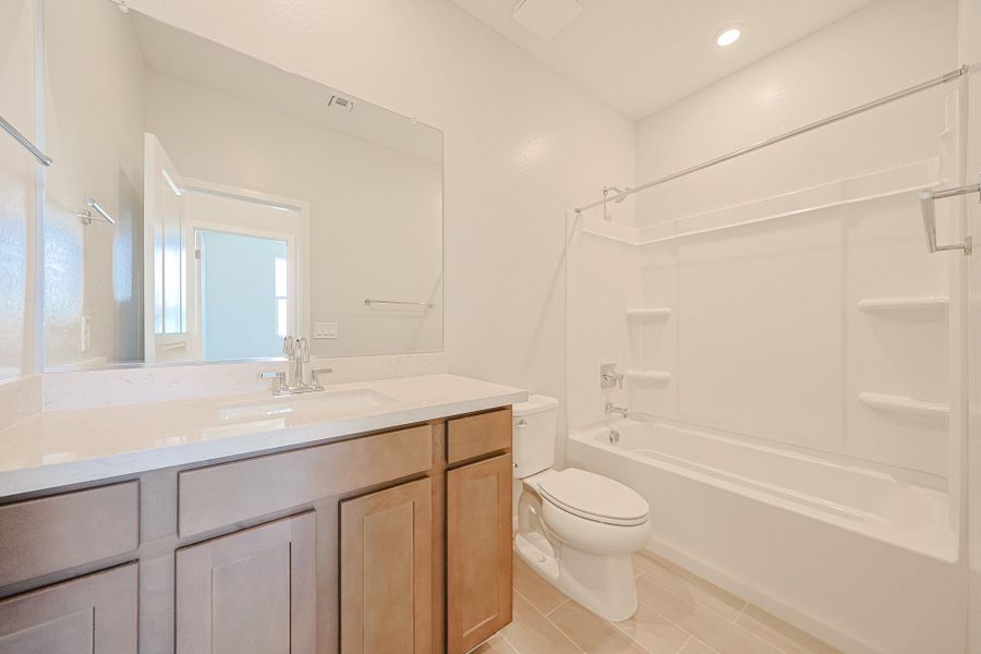 A bathroom with a tub toilet and sink. A bathroom with a tub toilet and sink.