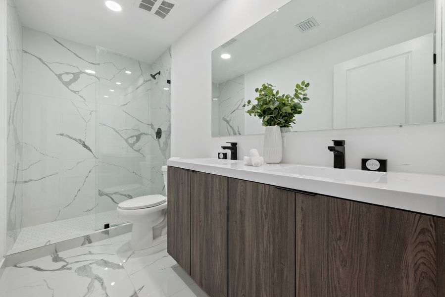 Representative furnished interior of a home built from the Model E by Onx Homes in On Alba, Florida City (Image 51).