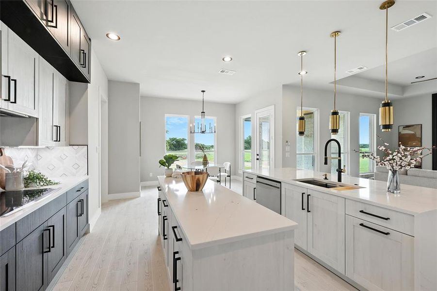 Kitchen with a kitchen island with sink, dishwasher, tasteful backsplash, black electric cooktop, and recessed lighting