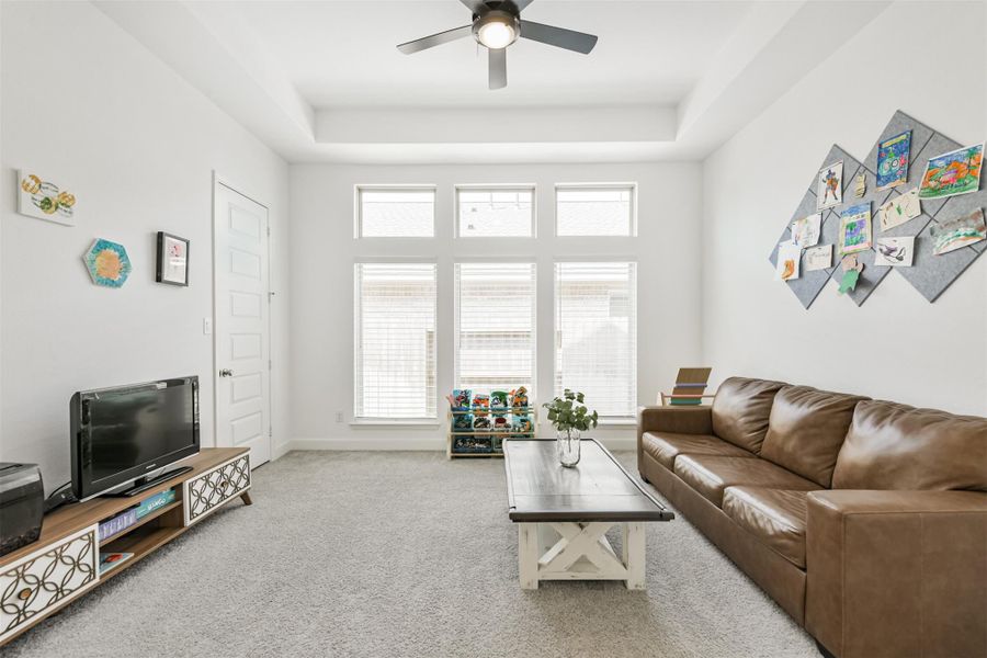 Game room opens off the hall with its own closet, wall of windows, trayed ceiling, and fan. Game room opens off the hall with its own closet, wall of windows, trayed ceiling, and fan.