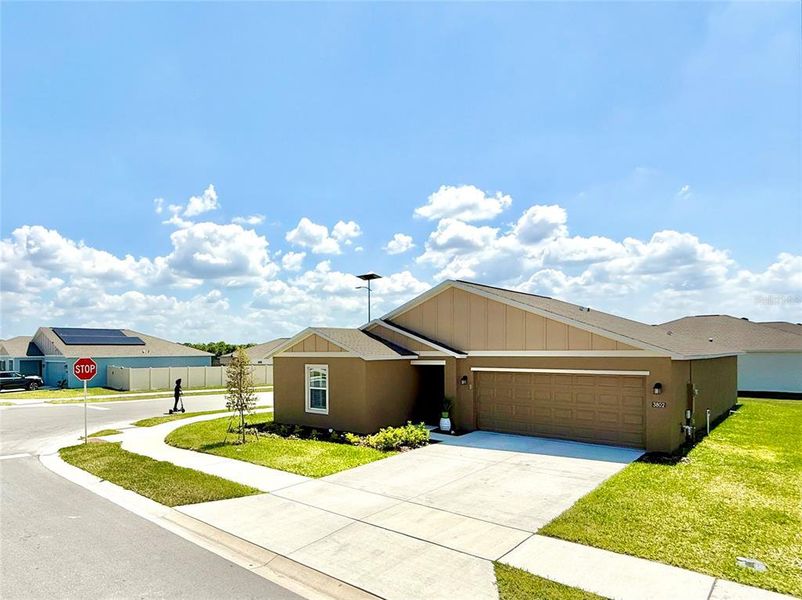 Front exterior of a new home in Ranches at Lake McLeod, Eagle Lake, FL, highlighting curb appeal (Image 2).