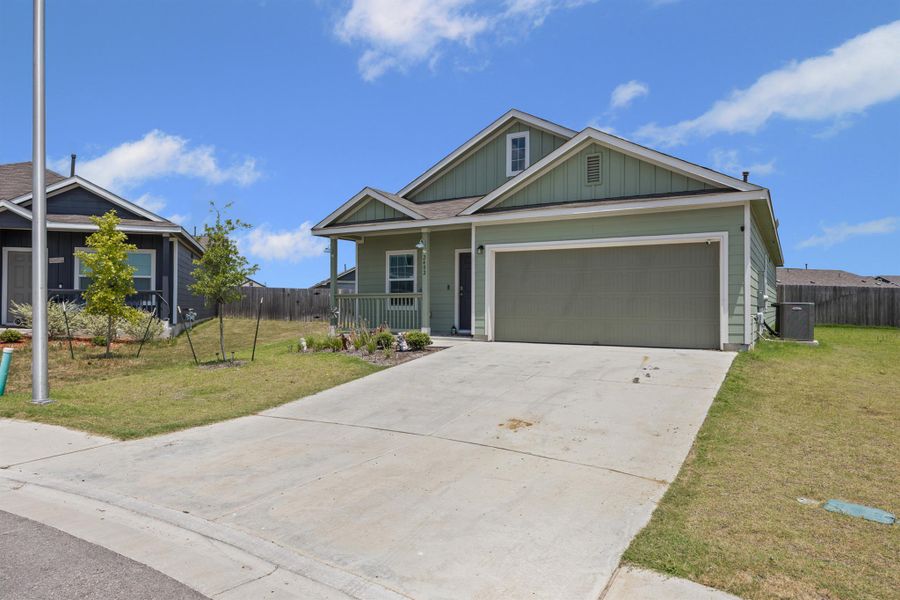 View of front of house with concrete driveway, a porch, board and batten siding, and a garage View of front of house with concrete driveway, a porch, board and batten siding, and a garage