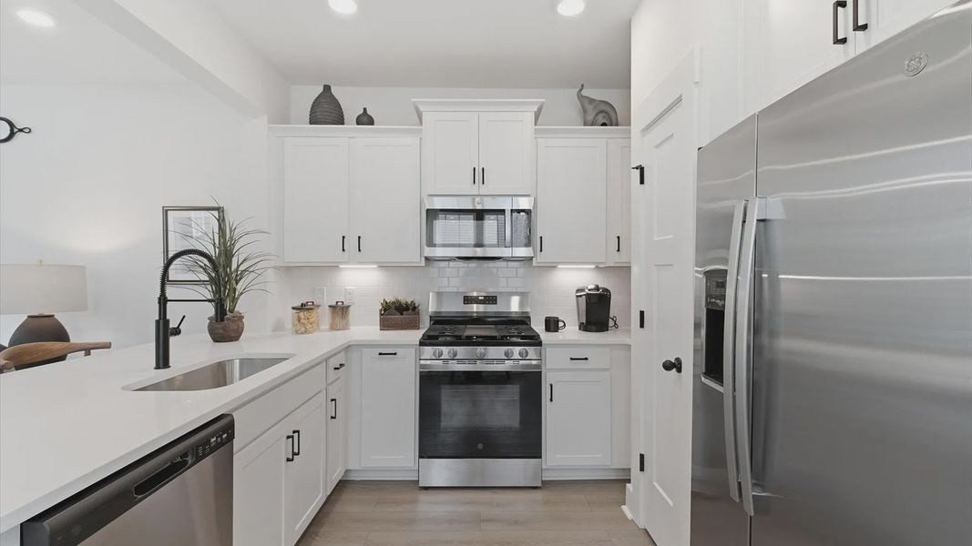 Tasteful kitchen with quartz countertops and modern finishes in a first-class DRB Homes design