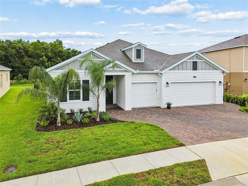 Front exterior of a new home in Providence, Davenport, FL, highlighting curb appeal (Image 28).