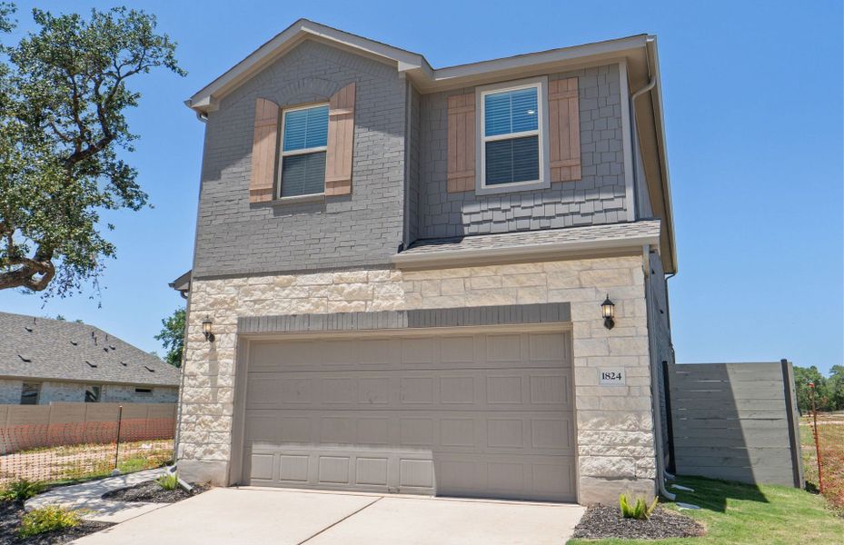 Front exterior of a new home in Wolf Ranch, Georgetown, TX, highlighting curb appeal (Image 24). Front exterior of a new home in Wolf Ranch, Georgetown, TX, highlighting curb appeal (Image 24).