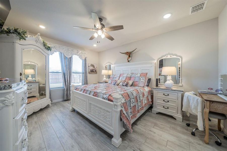 Bedroom featuring ceiling fan and light hardwood / wood-style floors