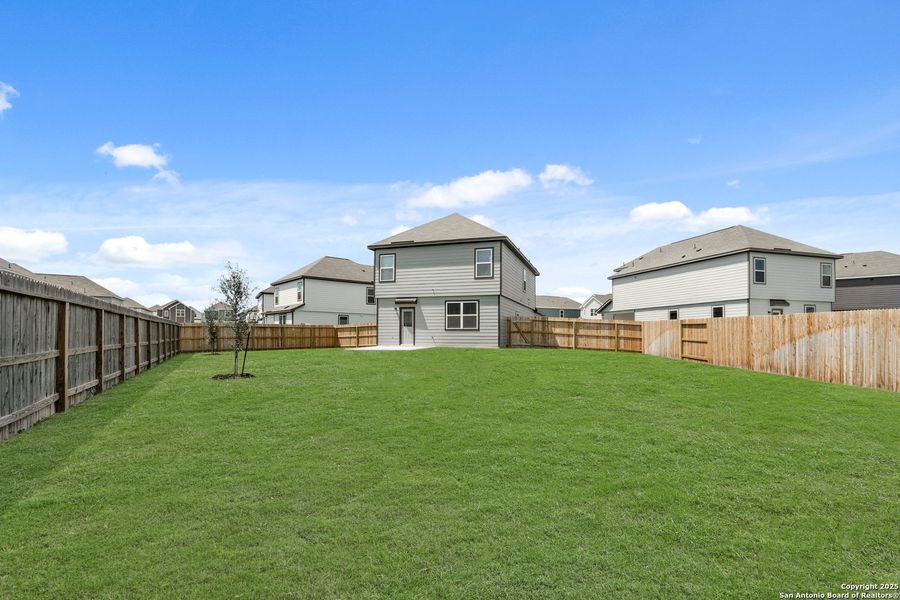Front exterior of a new home in Melissa Ranch, San Antonio, TX, highlighting curb appeal (Image 16). Front exterior of a new home in Melissa Ranch, San Antonio, TX, highlighting curb appeal (Image 16).