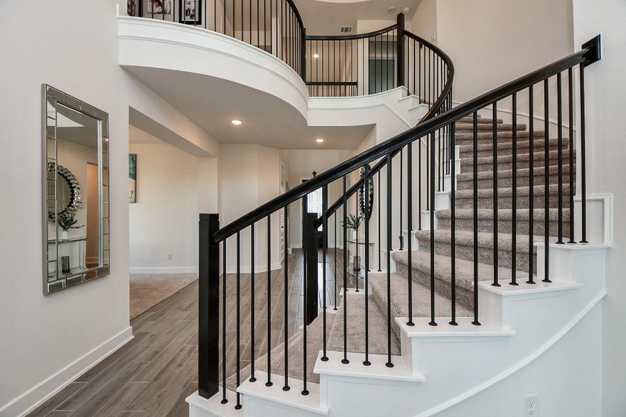 Striking dark wrought iron railings accompany the dramatic spiral staircase! Striking dark wrought iron railings accompany the dramatic spiral staircase!