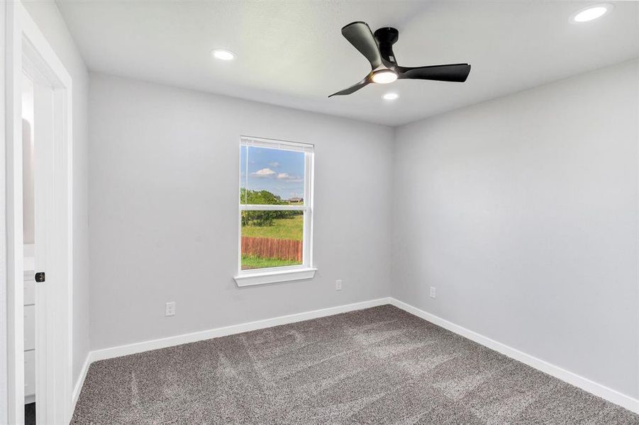 Unfurnished room with ceiling fan, dark carpet, recessed lighting, and baseboards