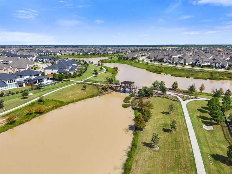 Elyson's master-planned design features extensive walking trails that wind around scenic lakes, perfect for a peaceful morning stroll or an evening jog. The community's focus on connecting residents with nature is evident in these beautiful spaces.