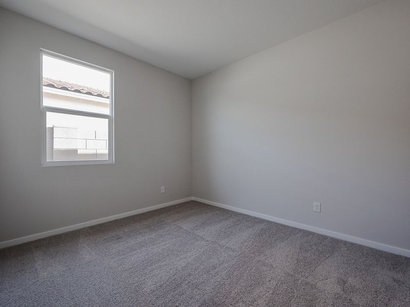 A room with a window and a carpet. A room with a window and a carpet.