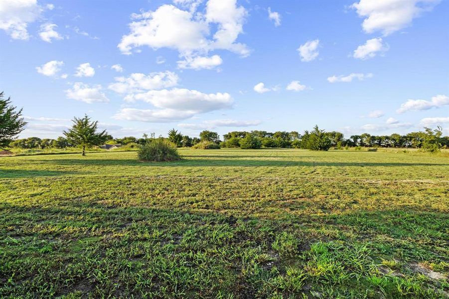 View of grassy yard featuring a rural view View of grassy yard featuring a rural view