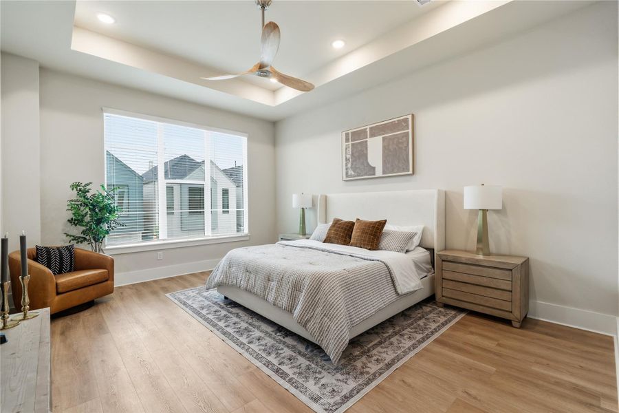 Spacious and well-proportioned, the primary suite measures 14x17 and is enhanced by tray ceilings and large windows that bring in natural light throughout the day. Dual closets provide added functionality without compromising the room’s openness. Spacious and well-proportioned, the primary suite measures 14x17 and is enhanced by tray ceilings and large windows that bring in natural light throughout the day. Dual closets provide added functionality without compromising the room’s openness.