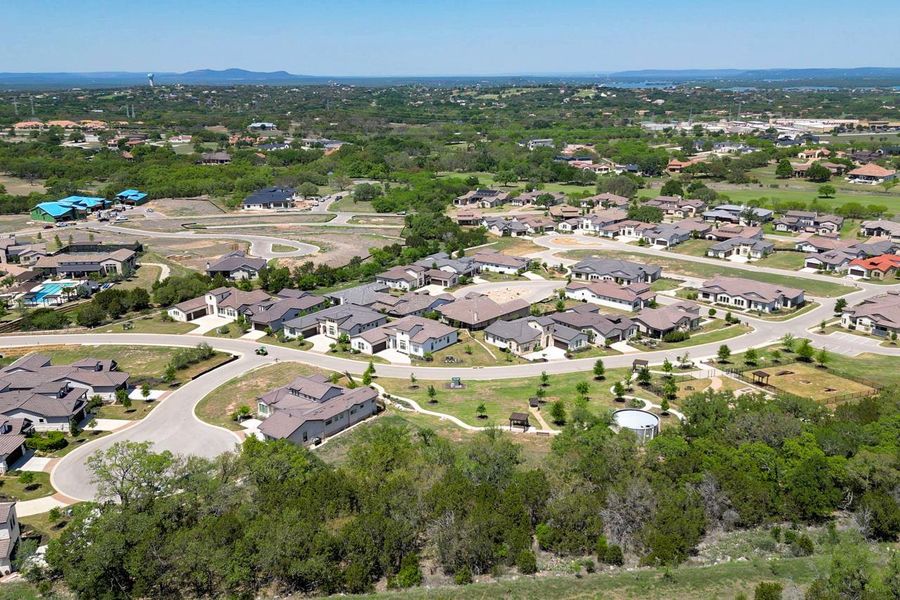 Aerial view of property and surrounding area featuring nearby suburban area