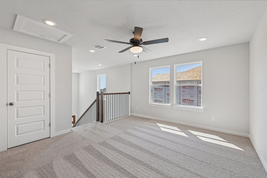 A room with a fan and a door.