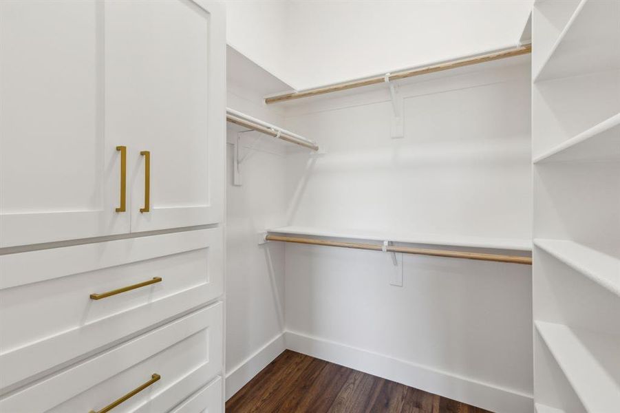 Walk in closet in the primary bedroom featuring amazing built ins Walk in closet in the primary bedroom featuring amazing built ins