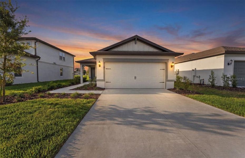 Front exterior of a new home in Twisted Oaks, Wildwood, FL, highlighting curb appeal (Image 2). Front exterior of a new home in Twisted Oaks, Wildwood, FL, highlighting curb appeal (Image 2).