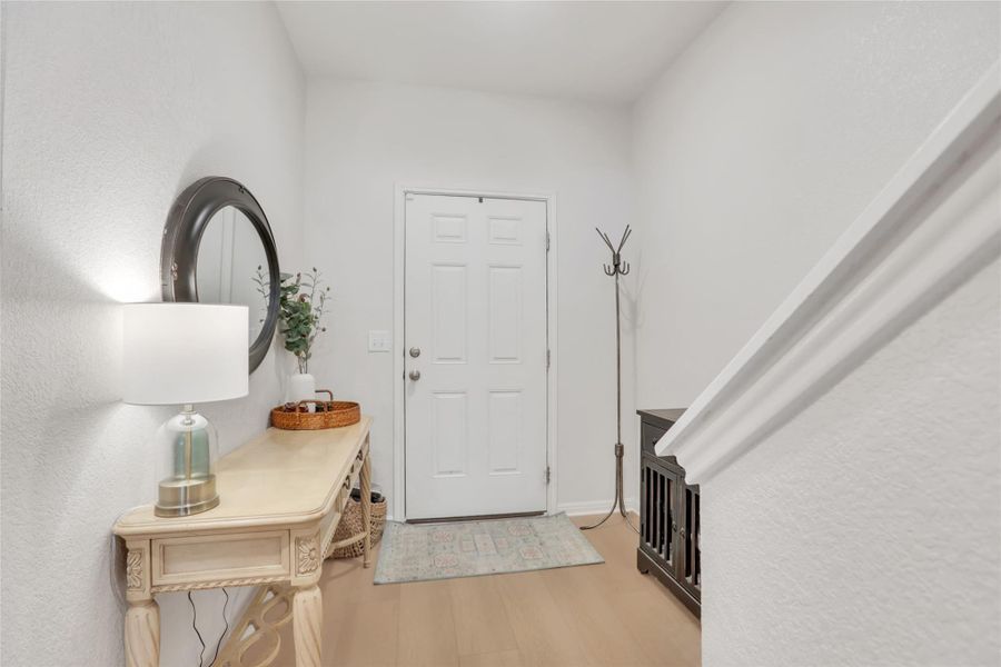 Entrance foyer featuring light wood-style floors