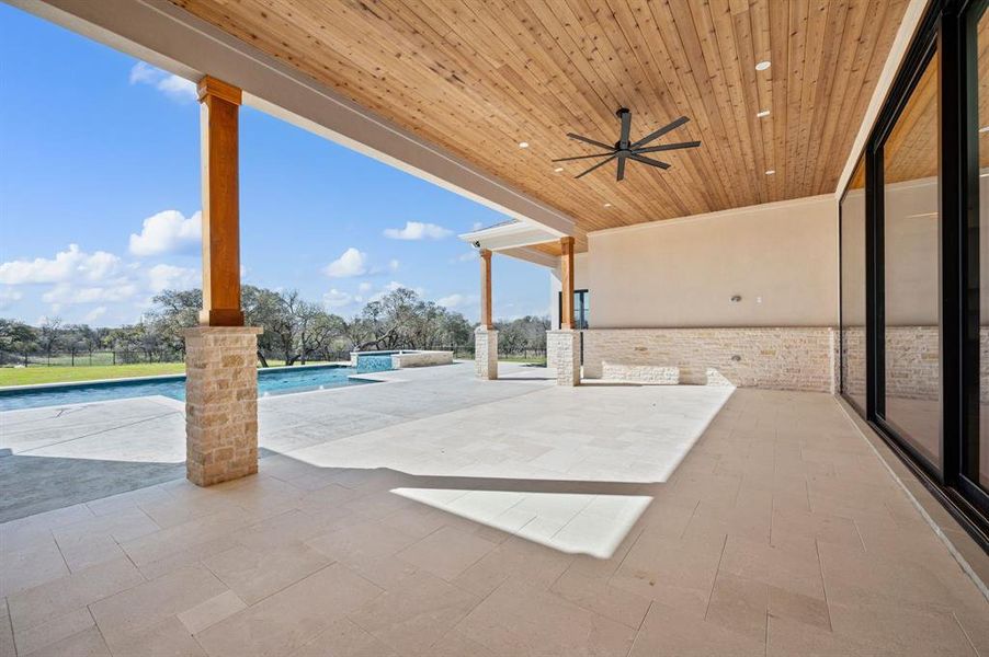 View of patio featuring ceiling fan and an outdoor pool
