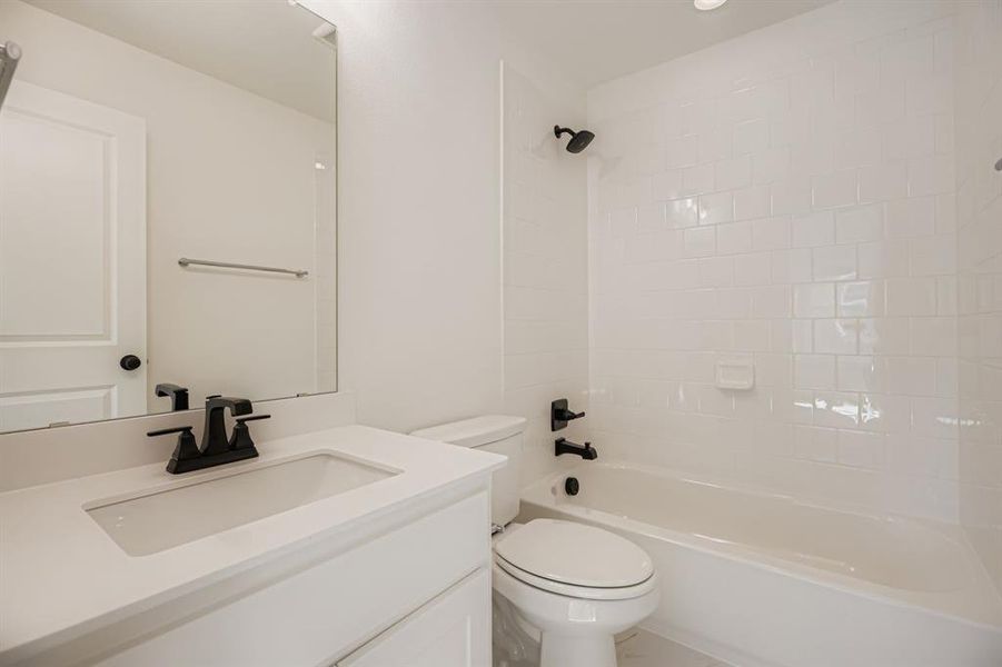 Bathroom with vanity and shower / washtub combination