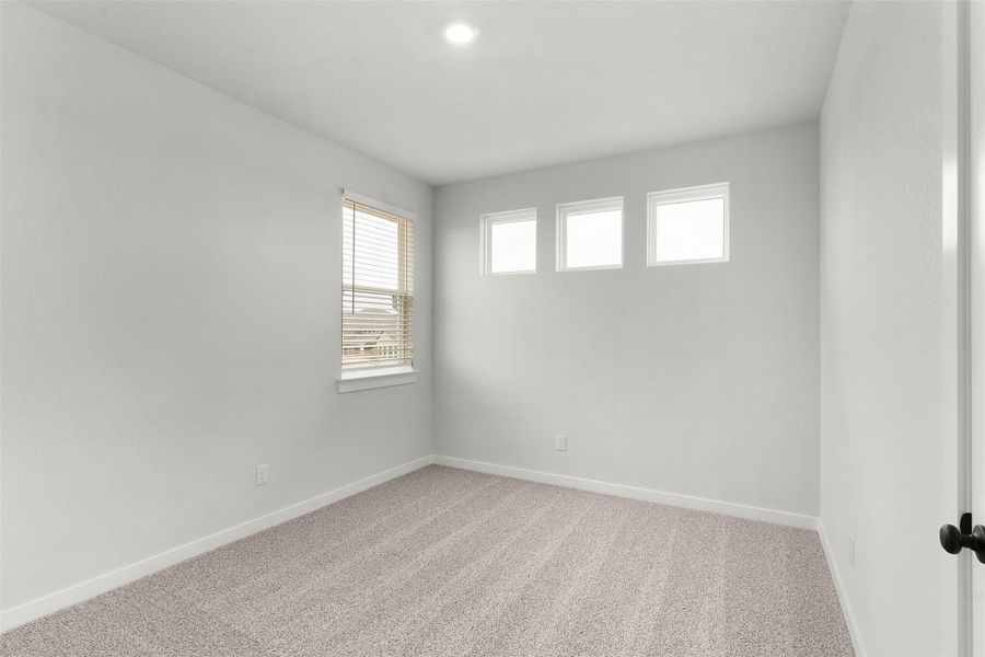 Carpeted empty room with baseboards and recessed lighting