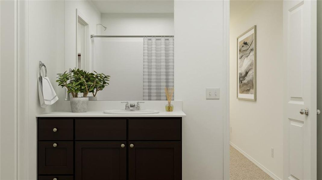 Bathroom featuring a shower with curtain and vanity