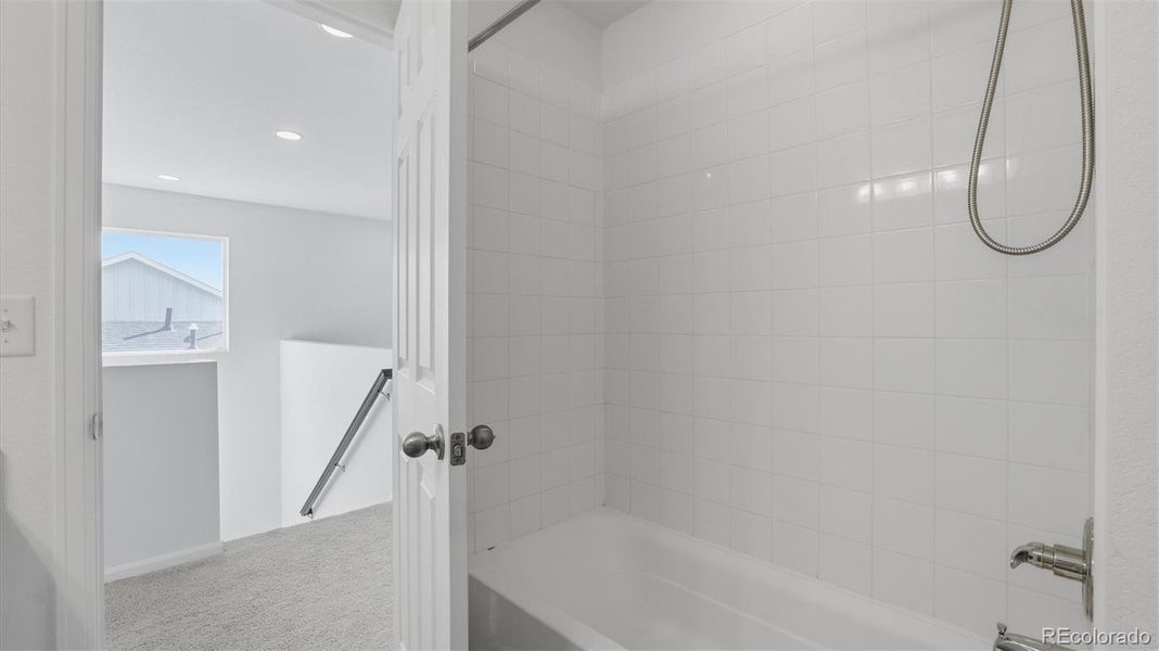 Stairs to the upper level and entrance into the Full Bathroom.