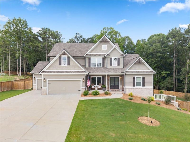 Front exterior of a new home in Woodland Hills, Loganville, GA, highlighting curb appeal (Image 2). Front exterior of a new home in Woodland Hills, Loganville, GA, highlighting curb appeal (Image 2).