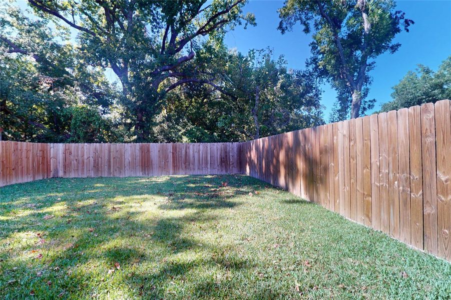 Spacious fenced yard with room to enjoy Spacious fenced yard with room to enjoy