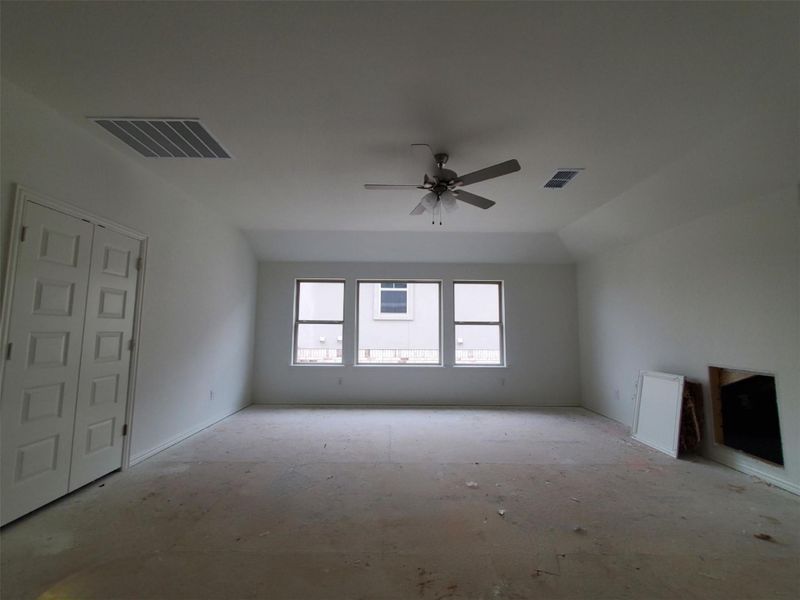 Unfurnished living room featuring ceiling fan and visible vents