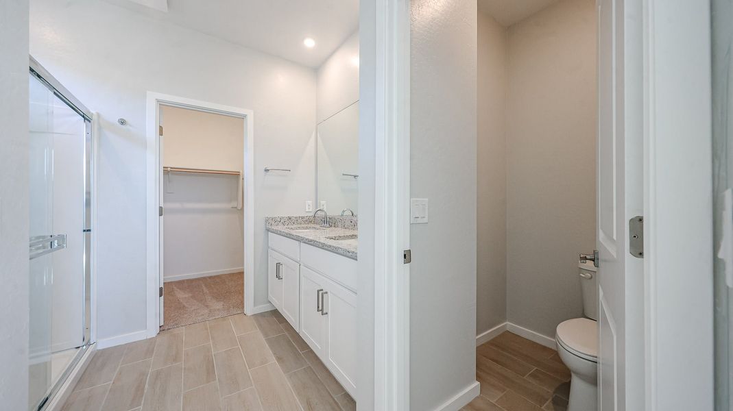 A bathroom with a shower unit and toilet. A bathroom with a shower unit and toilet.
