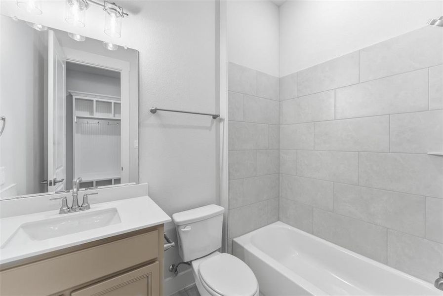 Full bath featuring vanity and washtub / shower combination