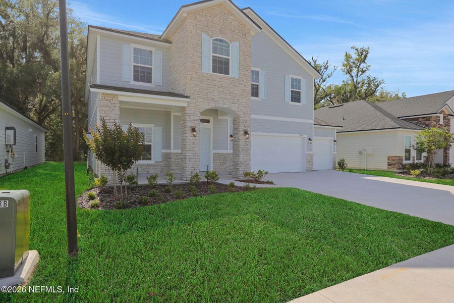 Front exterior of a new home in Jennings Farm, Middleburg, FL, highlighting curb appeal (Image 21). Front exterior of a new home in Jennings Farm, Middleburg, FL, highlighting curb appeal (Image 21).