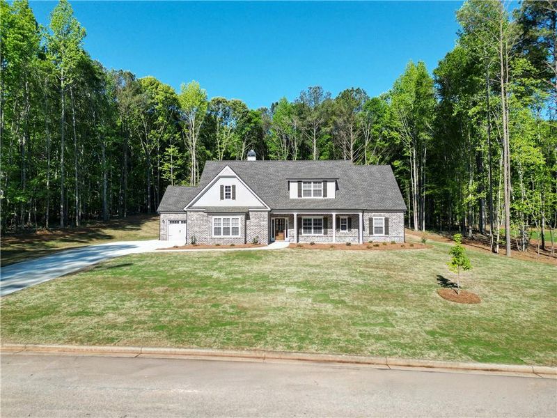 Front exterior of a new home in Ella Springs, Covington, GA, highlighting curb appeal (Image 1). Front exterior of a new home in Ella Springs, Covington, GA, highlighting curb appeal (Image 1).