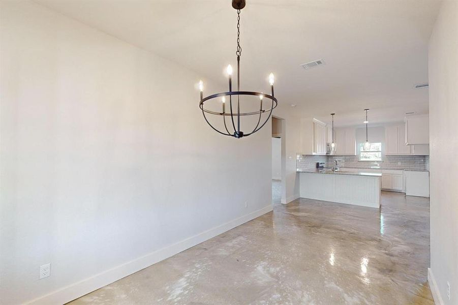 Unfurnished dining area with a chandelier and sink