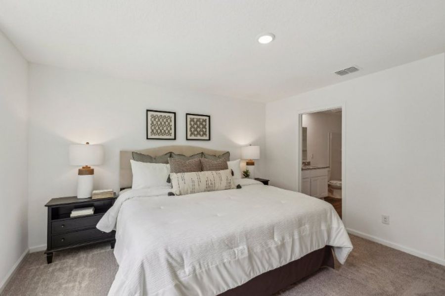 A bedroom with a bed and lamps. A bedroom with a bed and lamps.