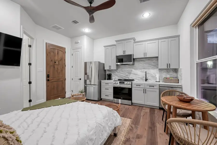 Full kitchen offers LG stainless appliances and marble counters and backsplash.