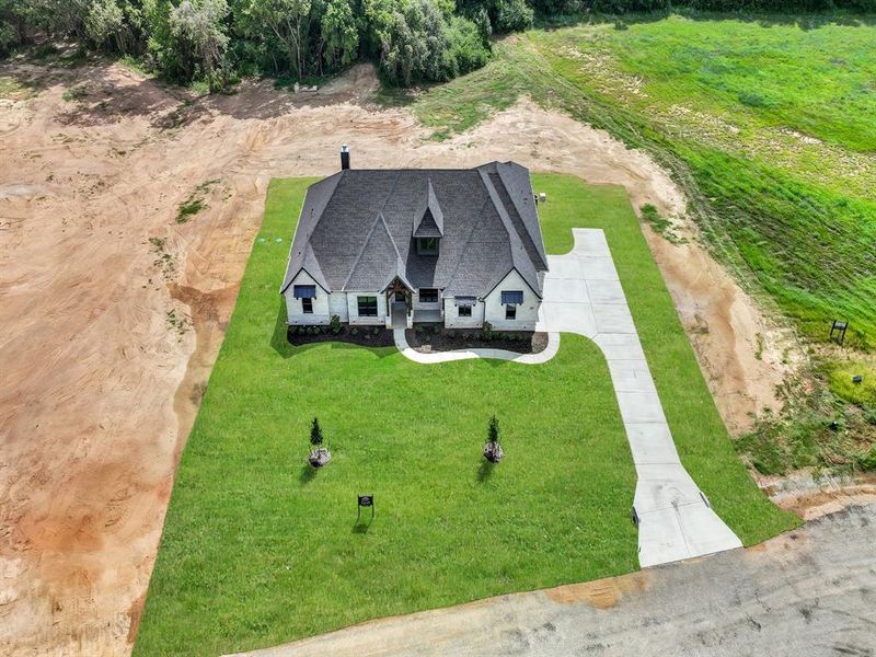 Front exterior of a new home in , Weatherford, TX, highlighting curb appeal (Image 2).