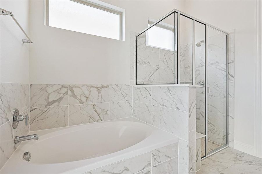 Bathroom featuring shower with separate bathtub